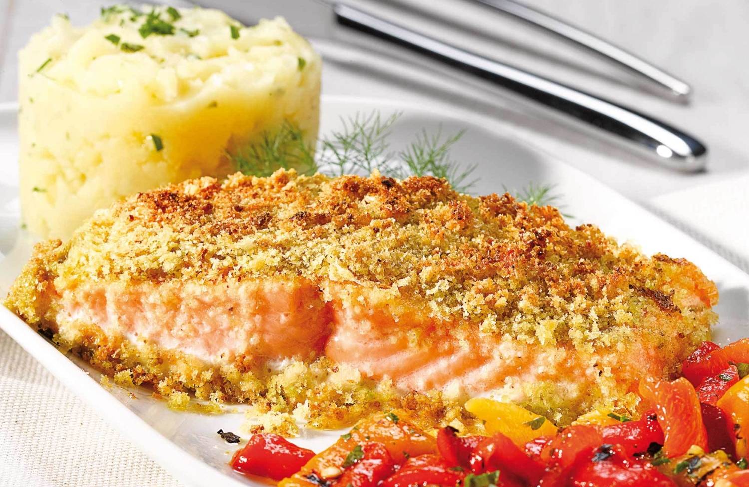 Pistachio salmon steak with roasted potatoes and peppers